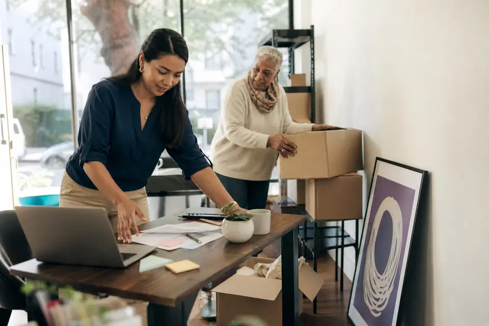 Nonprofit staff setting up a desk in a new office space